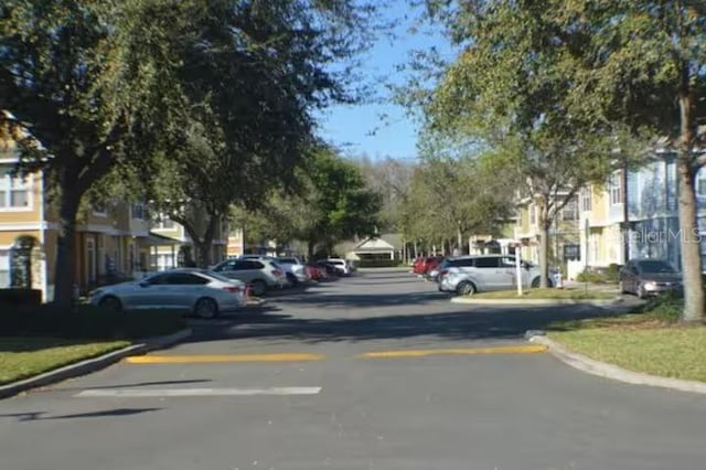 view of street with curbs and a residential view