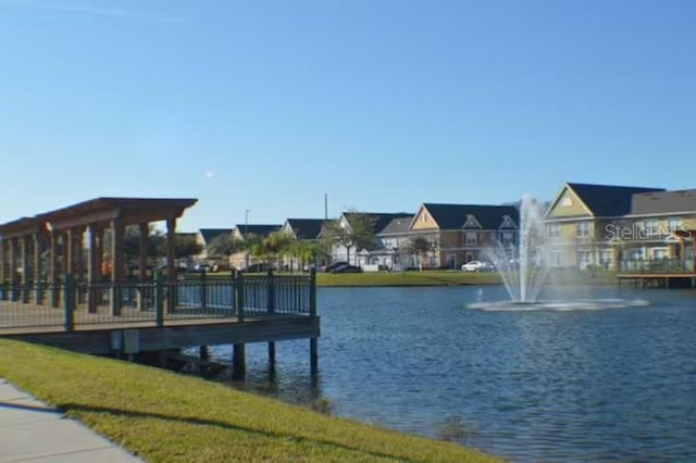 dock area with a water view and a residential view