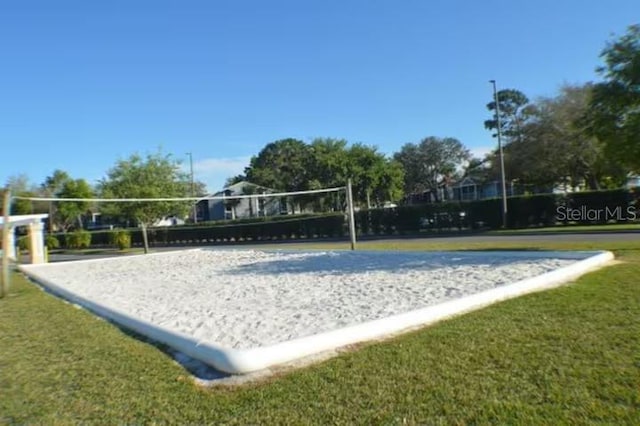 surrounding community featuring a yard and volleyball court