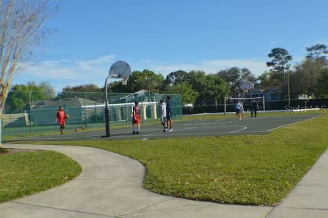 view of sport court featuring community basketball court, a yard, volleyball court, and fence