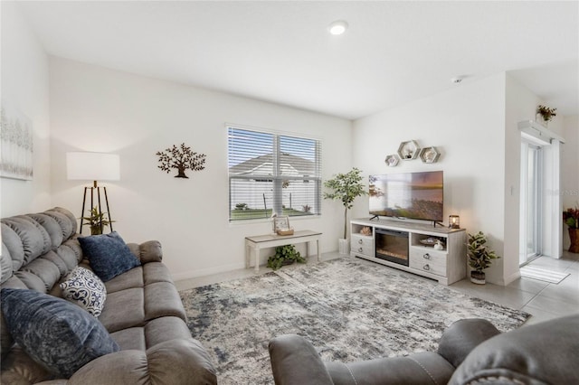 living room featuring light tile patterned floors and baseboards