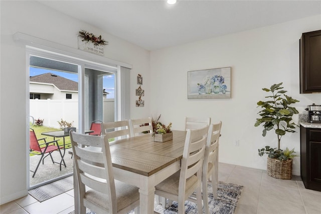 dining space featuring light tile patterned floors