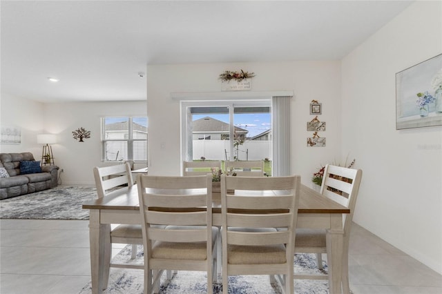 dining space featuring light tile patterned flooring