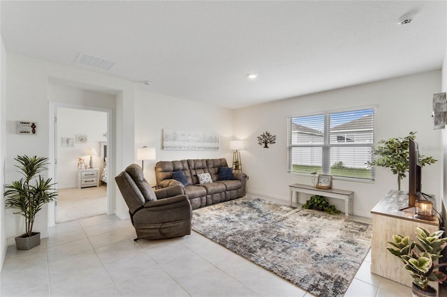 living area with light tile patterned floors and visible vents