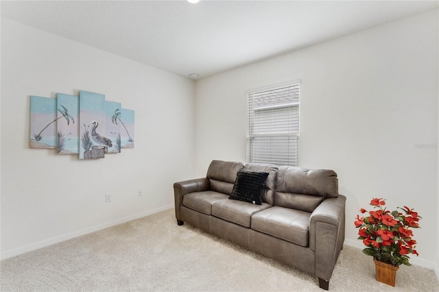 sitting room featuring light carpet and baseboards