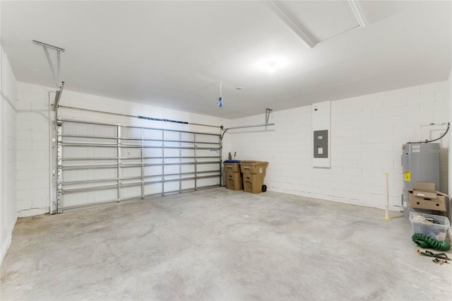 garage featuring concrete block wall, electric panel, and water heater