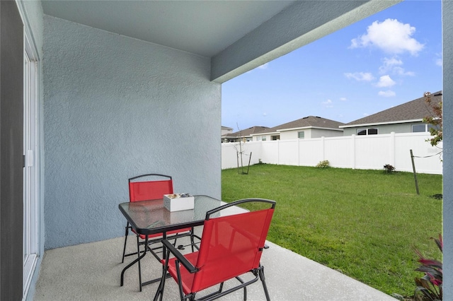 view of patio / terrace with outdoor dining space and fence