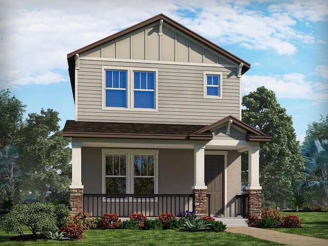 craftsman-style house featuring board and batten siding, a front yard, roof with shingles, and a porch