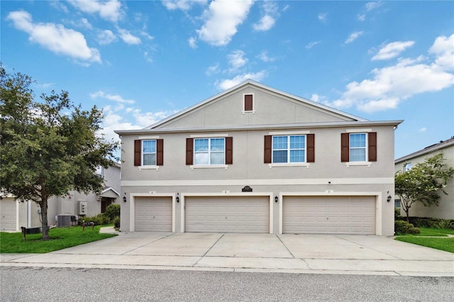 3528 Seneca Club Loop Unit 103 C, Orlando, FL 32808 - traditional-style house featuring central air condition unit, an attached garage, concrete driveway, and stucco siding