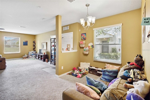 rec room featuring light carpet, a notable chandelier, and baseboards