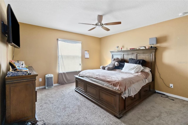 bedroom with light carpet, baseboards, and a ceiling fan