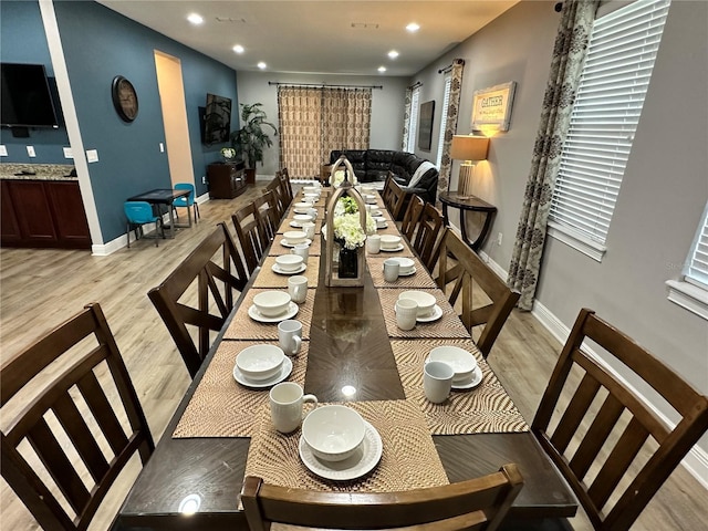 dining room with light wood-style floors, baseboards, and recessed lighting