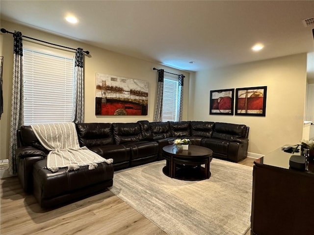 living area with visible vents, baseboards, wood finished floors, and recessed lighting