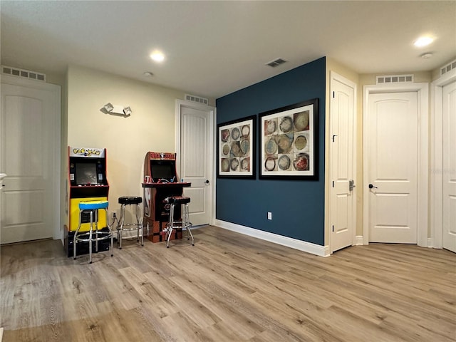 office space with visible vents, baseboards, and wood finished floors