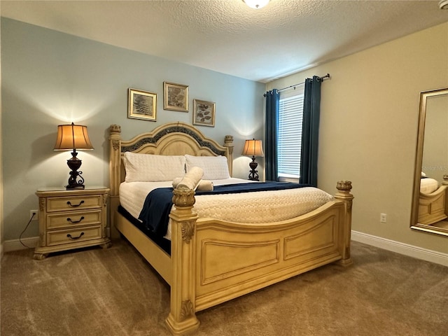 bedroom featuring dark carpet, a textured ceiling, and baseboards