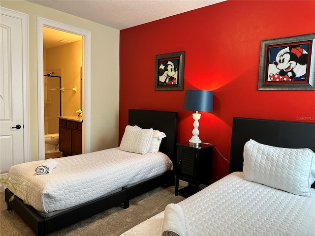 carpeted bedroom featuring ensuite bath and an accent wall