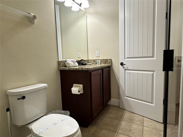 bathroom featuring vanity, toilet, and tile patterned floors