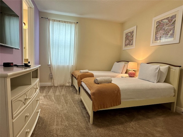 bedroom featuring carpet and baseboards