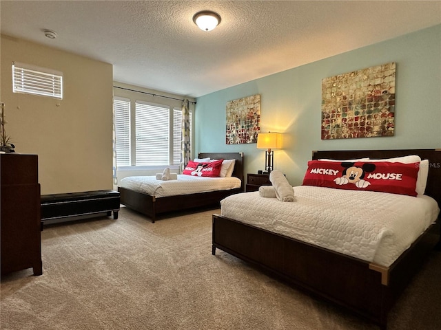 carpeted bedroom featuring a textured ceiling