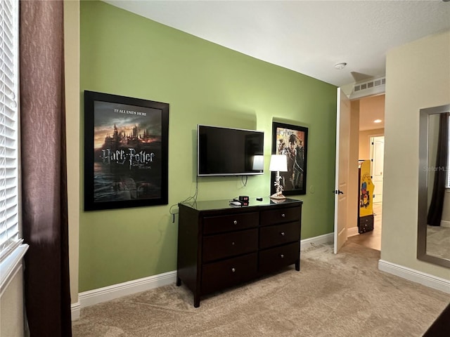 bedroom featuring baseboards, visible vents, and light colored carpet