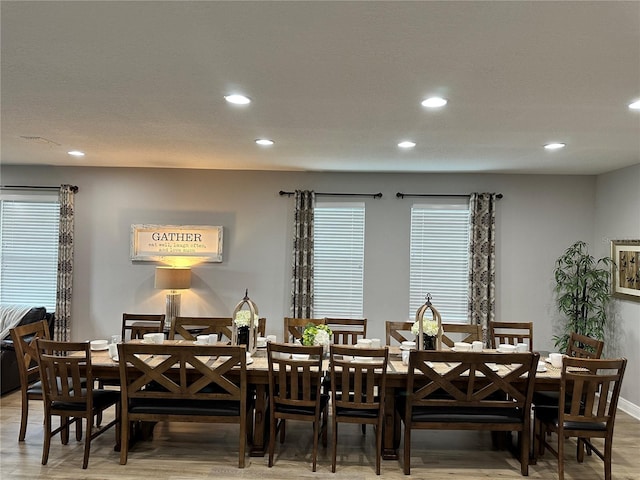 dining room with wood finished floors and recessed lighting