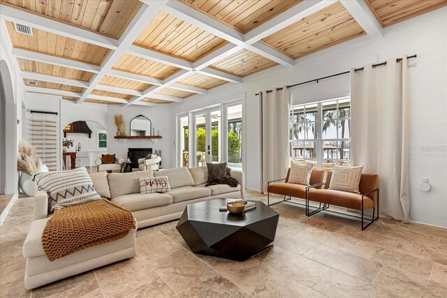 living area with visible vents, coffered ceiling, beam ceiling, a fireplace, and wood ceiling