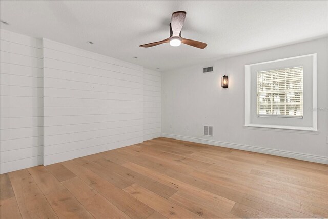 spare room with visible vents, baseboards, light wood-style floors, and ceiling fan