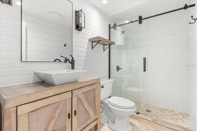 full bath featuring a stall shower, toilet, and vanity