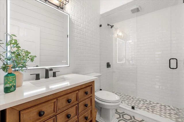 bathroom featuring a stall shower, toilet, and vanity