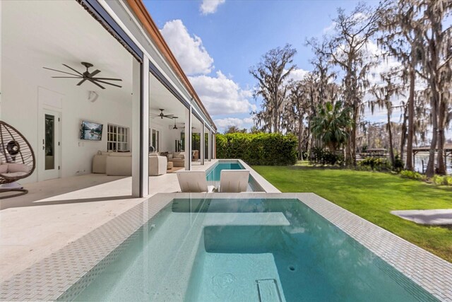 view of swimming pool featuring a lawn, a ceiling fan, a patio, outdoor lounge area, and an in ground hot tub