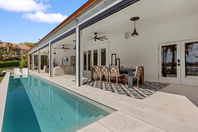 outdoor pool with a ceiling fan, a patio, french doors, and outdoor lounge area