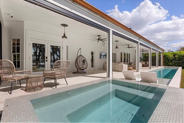 outdoor pool with french doors, an in ground hot tub, a ceiling fan, and a patio area