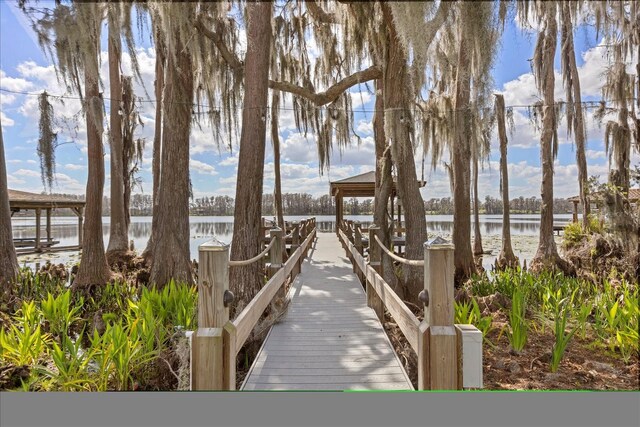 surrounding community featuring a gazebo and a water view