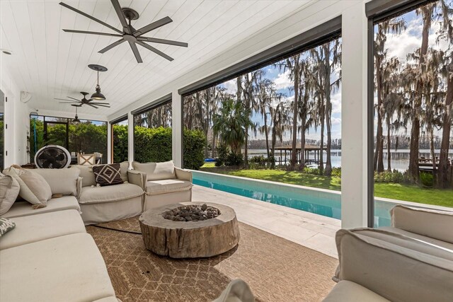 sunroom with a swimming pool, a healthy amount of sunlight, wooden ceiling, and a water view