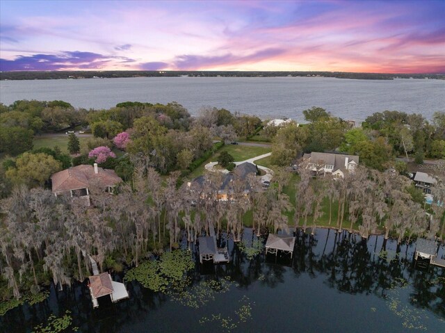 aerial view at dusk with a water view