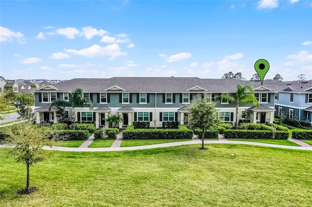 townhome / multi-family property featuring a residential view and a front yard