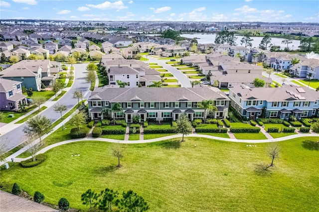 bird's eye view featuring a water view and a residential view