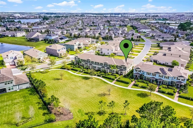 drone / aerial view featuring a water view and a residential view