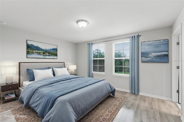 bedroom featuring light wood-type flooring and baseboards