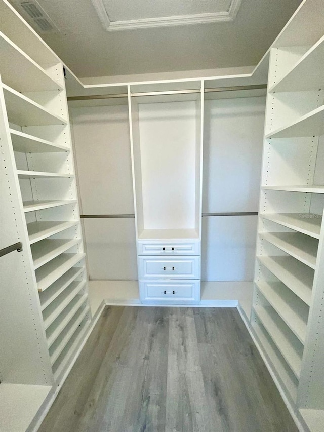 spacious closet with wood finished floors and visible vents