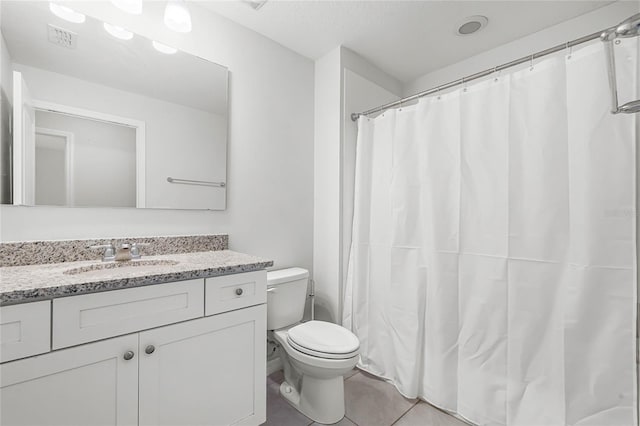 full bath with toilet, vanity, visible vents, and tile patterned floors