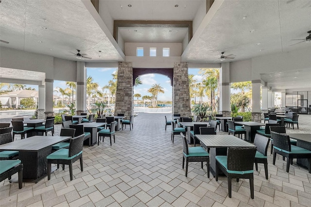 view of patio / terrace with ceiling fan, outdoor dining area, and an outdoor living space