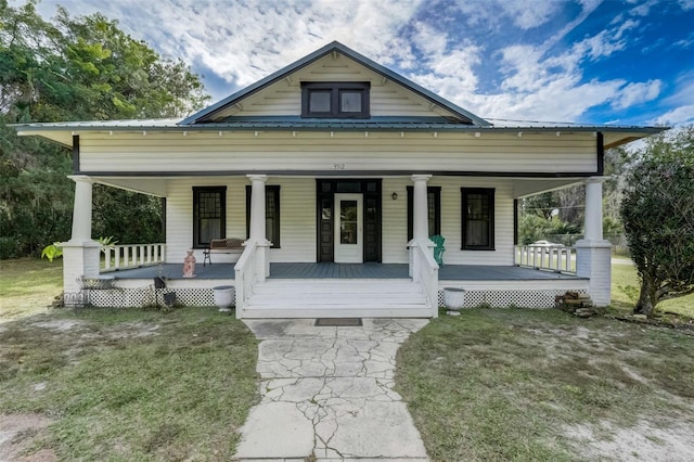 view of front of home featuring covered porch and metal roof