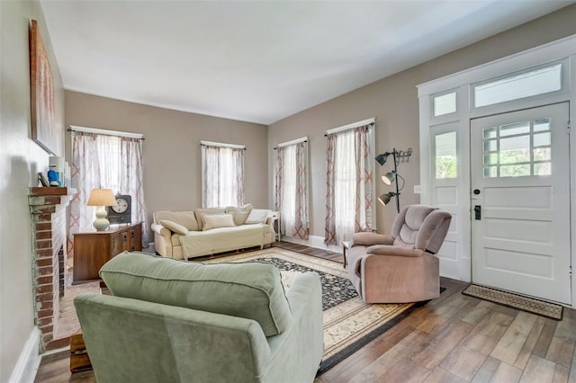 living room with a healthy amount of sunlight, baseboards, and wood finished floors