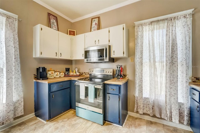 kitchen featuring baseboards, stainless steel appliances, crown molding, blue cabinetry, and white cabinetry