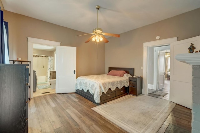 bedroom with light wood-type flooring, ceiling fan, and ensuite bathroom