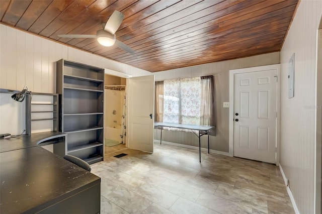 unfurnished office with wooden ceiling, visible vents, ceiling fan, and baseboards