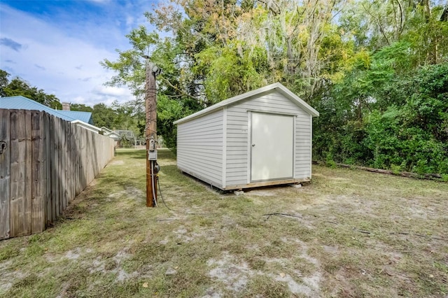 view of shed featuring fence