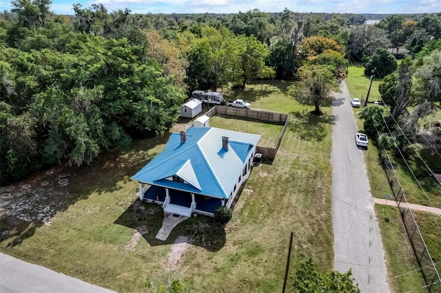 drone / aerial view featuring a forest view