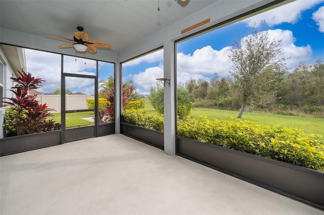 unfurnished sunroom featuring a ceiling fan